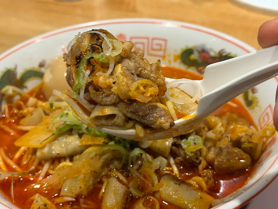 Egg topping added to motsu ramen