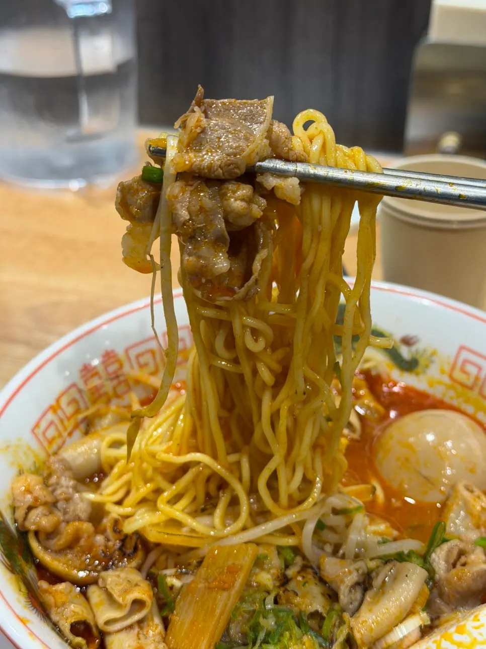 A bite of motsu ramen noodles and broth