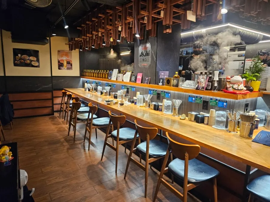 Interior and bar table lit up at Mentsuru City Hall Branch