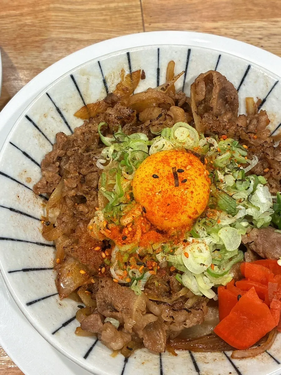 Gyudon rice bowl topped with egg yolk