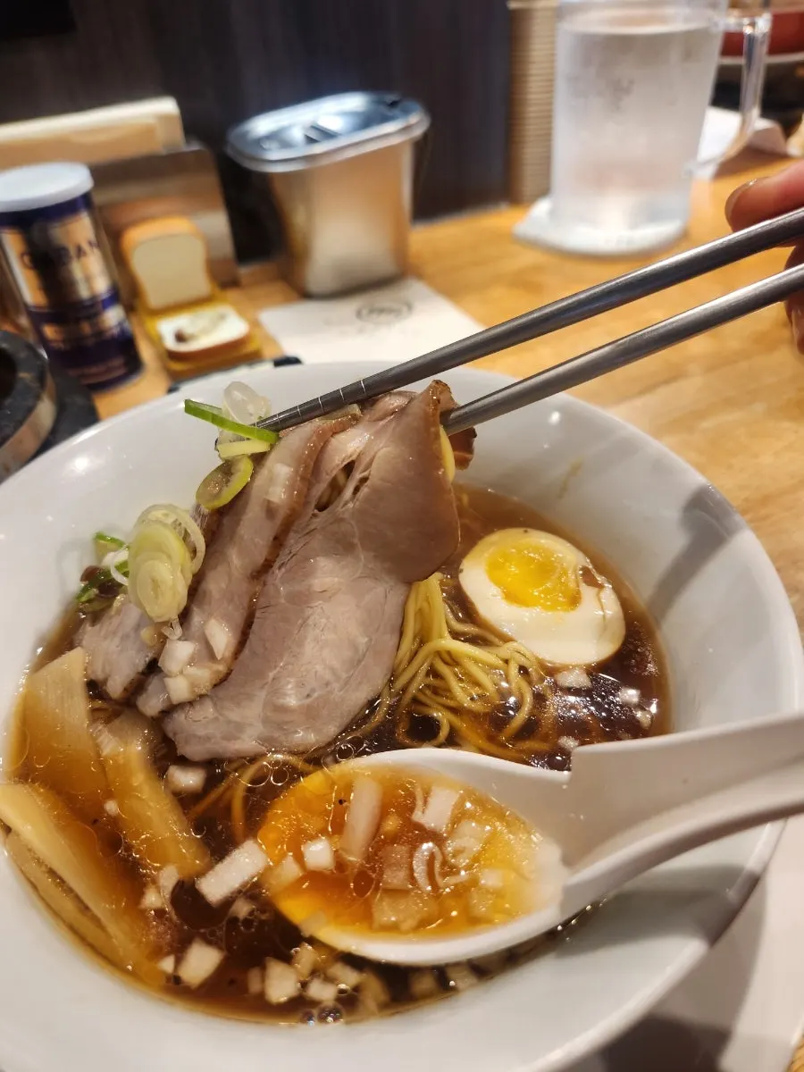 A bowl of shoyu ramen with clear soy-based broth
