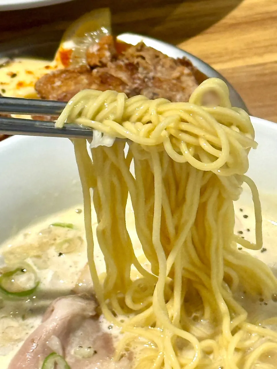 Thin noodles soaked in tori paitan broth