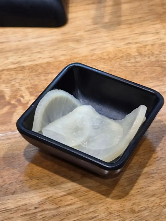 Pickled radish portioned onto a small plate