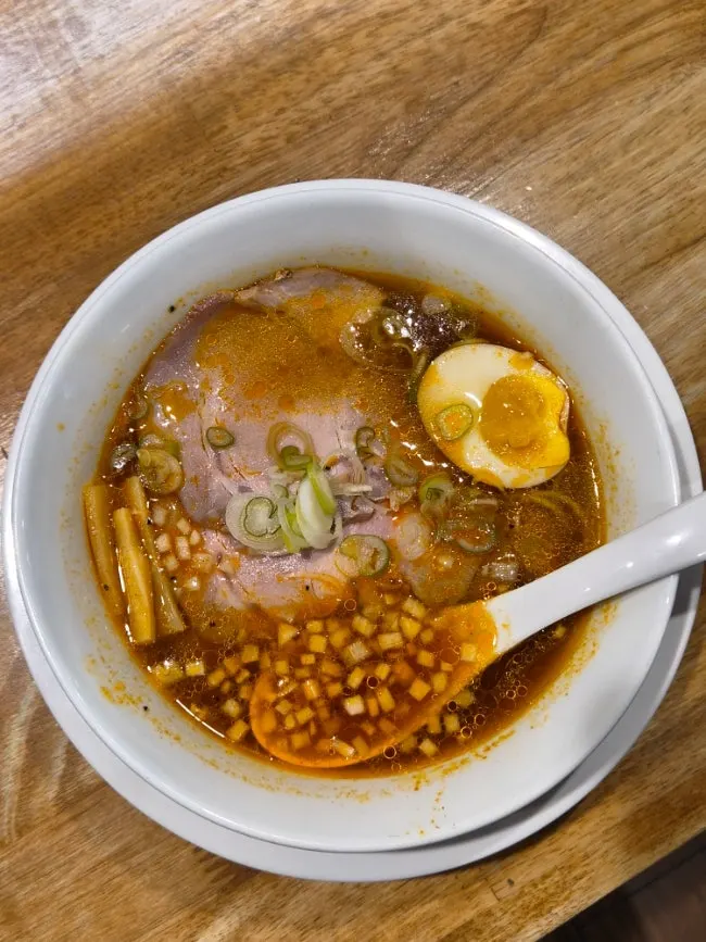 Close-up of the spicy, rich broth of the spicy soy ramen
