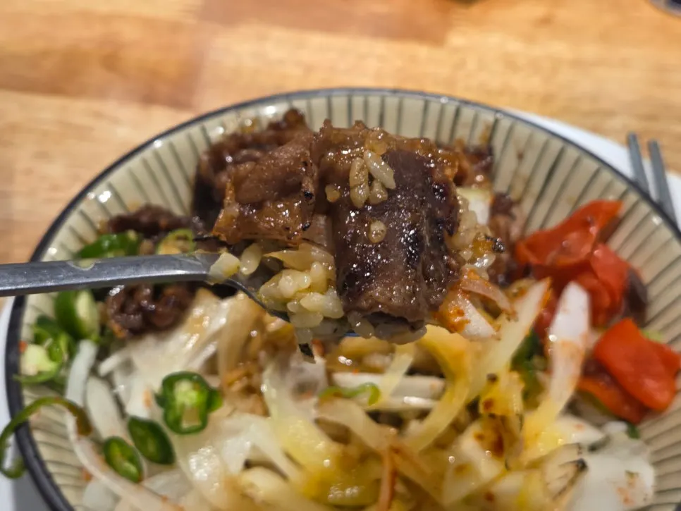 Beef intestine rice bowl served with pickled radish, ginger, and cheongyang chili peppers