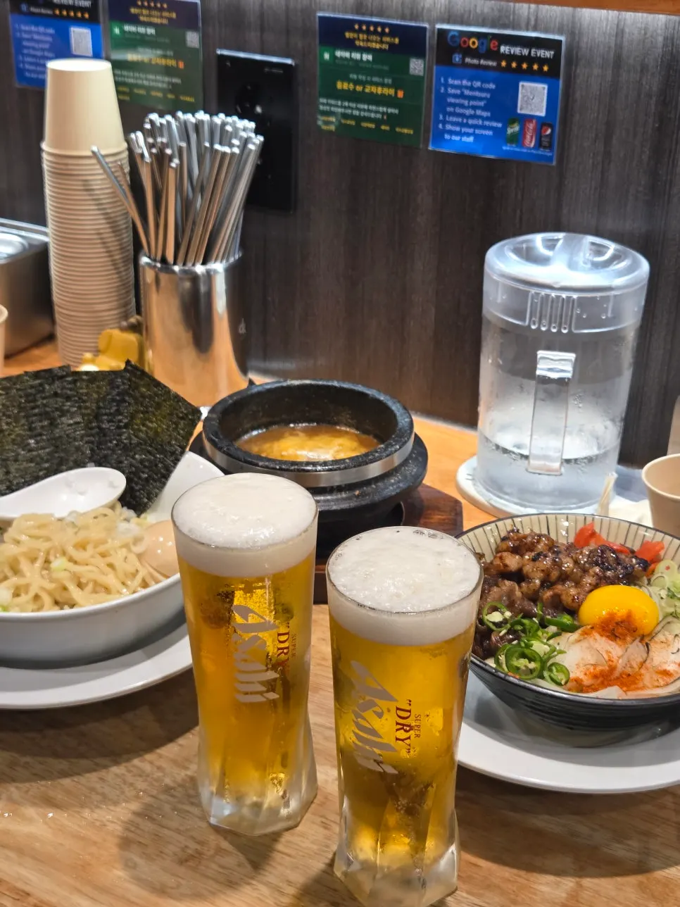 Table with tsukemen, hormone-don, and draft beer together