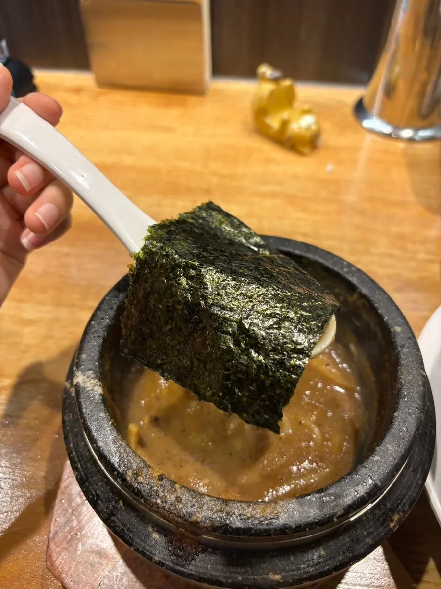 Dipping tsukemen noodles into the broth