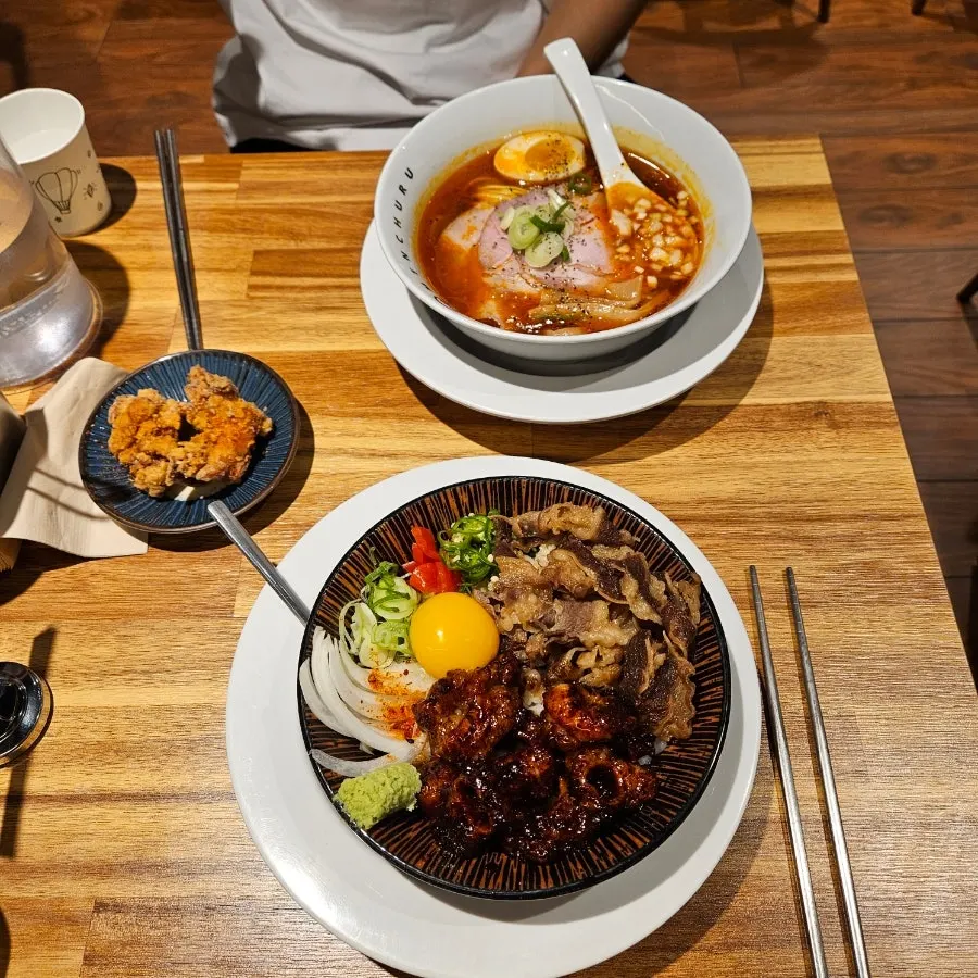 Table spread of spicy shoyu ramen, hormone-dong, and karaage