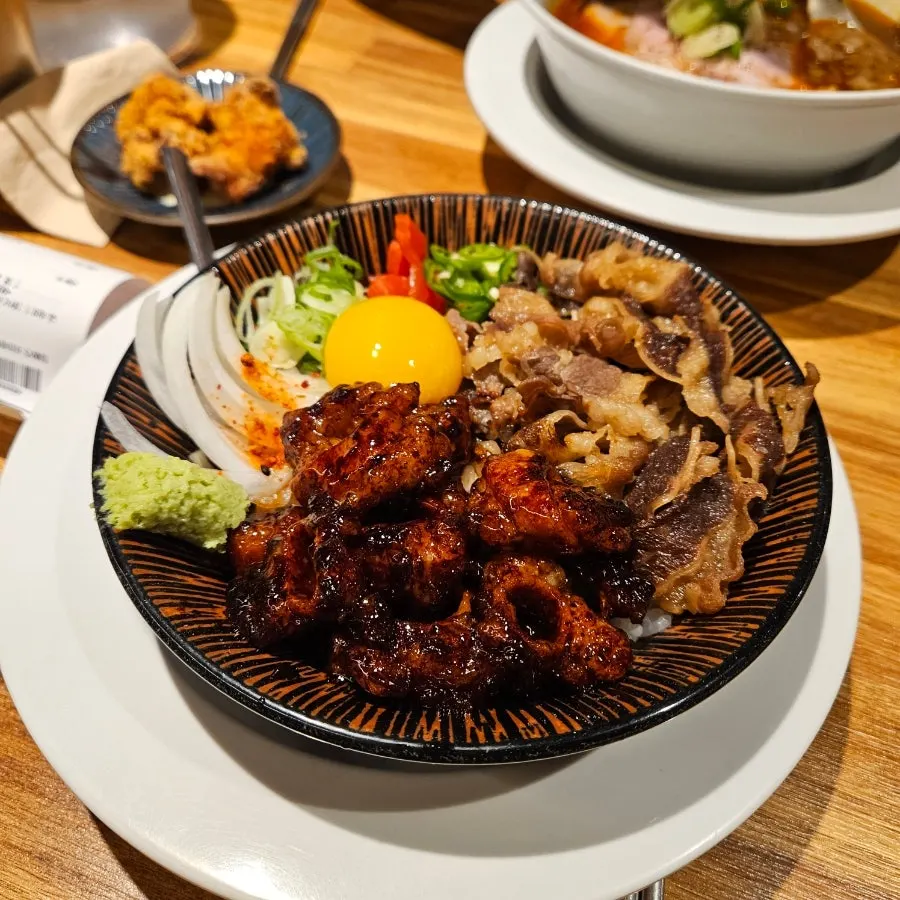 Beef intestine rice bowl with onion, chili, and wasabi