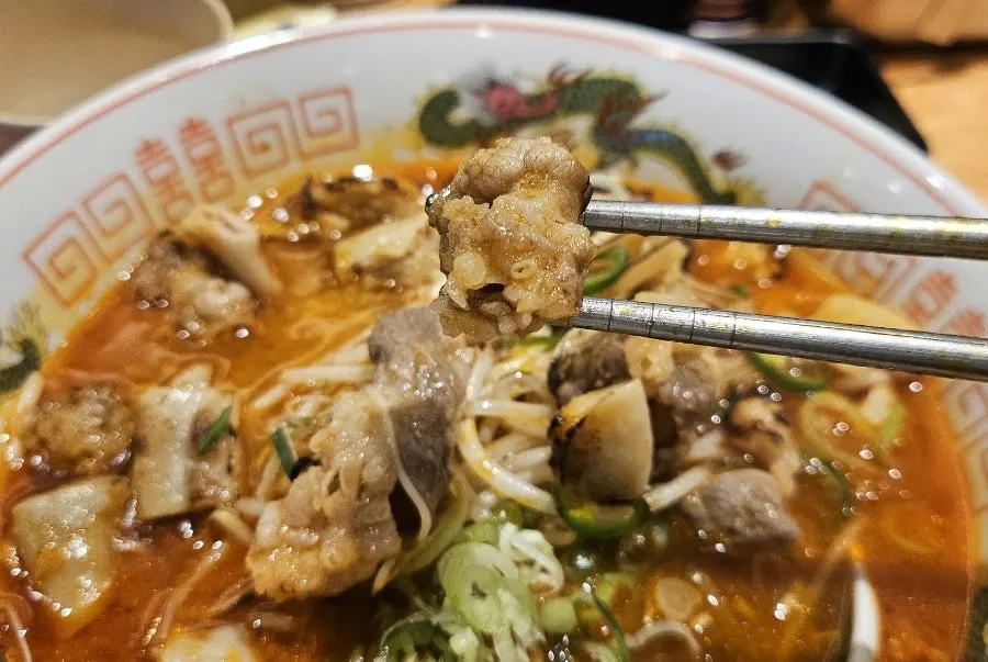Motsu ramen topped with green onion and cheongyang chili