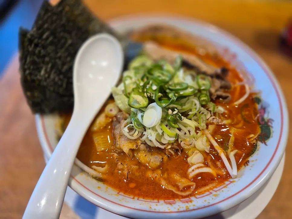 Spicy motsu ramen topped with scallions and cheongyang chili