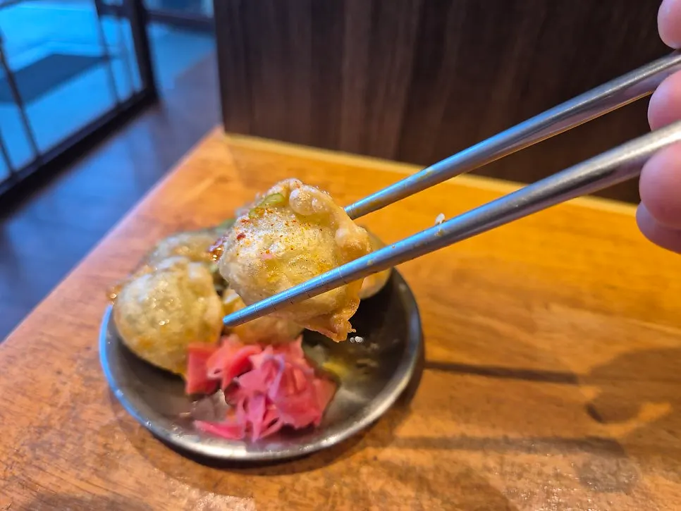 Round fried gyoza served with pickled ginger