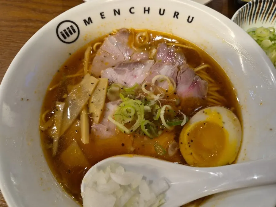Close-up of the spicy shoyu ramen broth and toppings