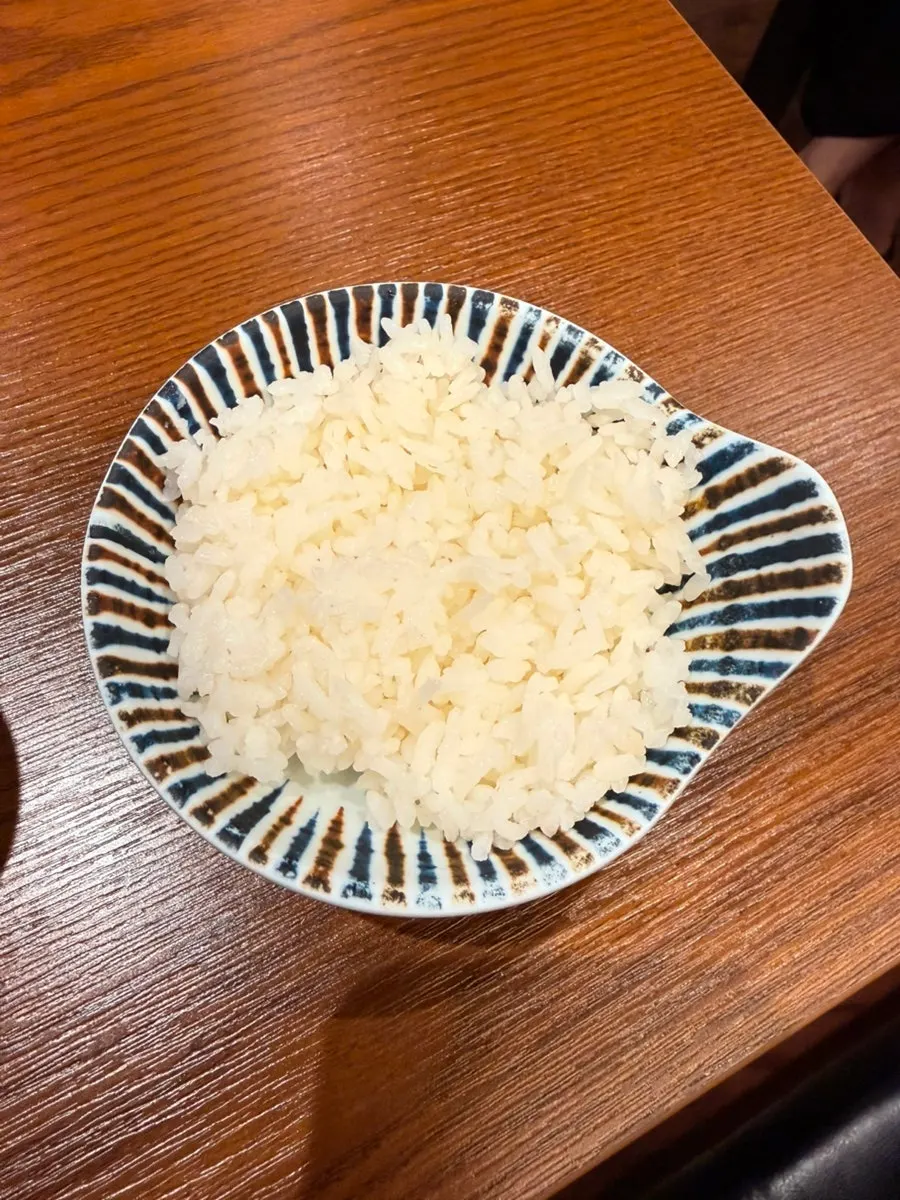 Extra rice mixed into shoyu ramen soup