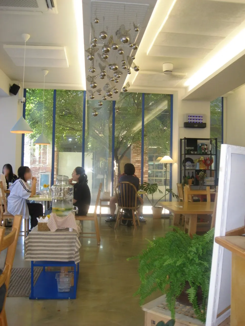 High-ceilinged seating by floor-to-ceiling windows