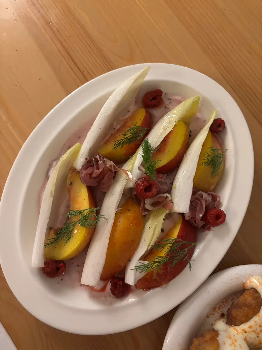 Endive salad plated with seasonal fruit