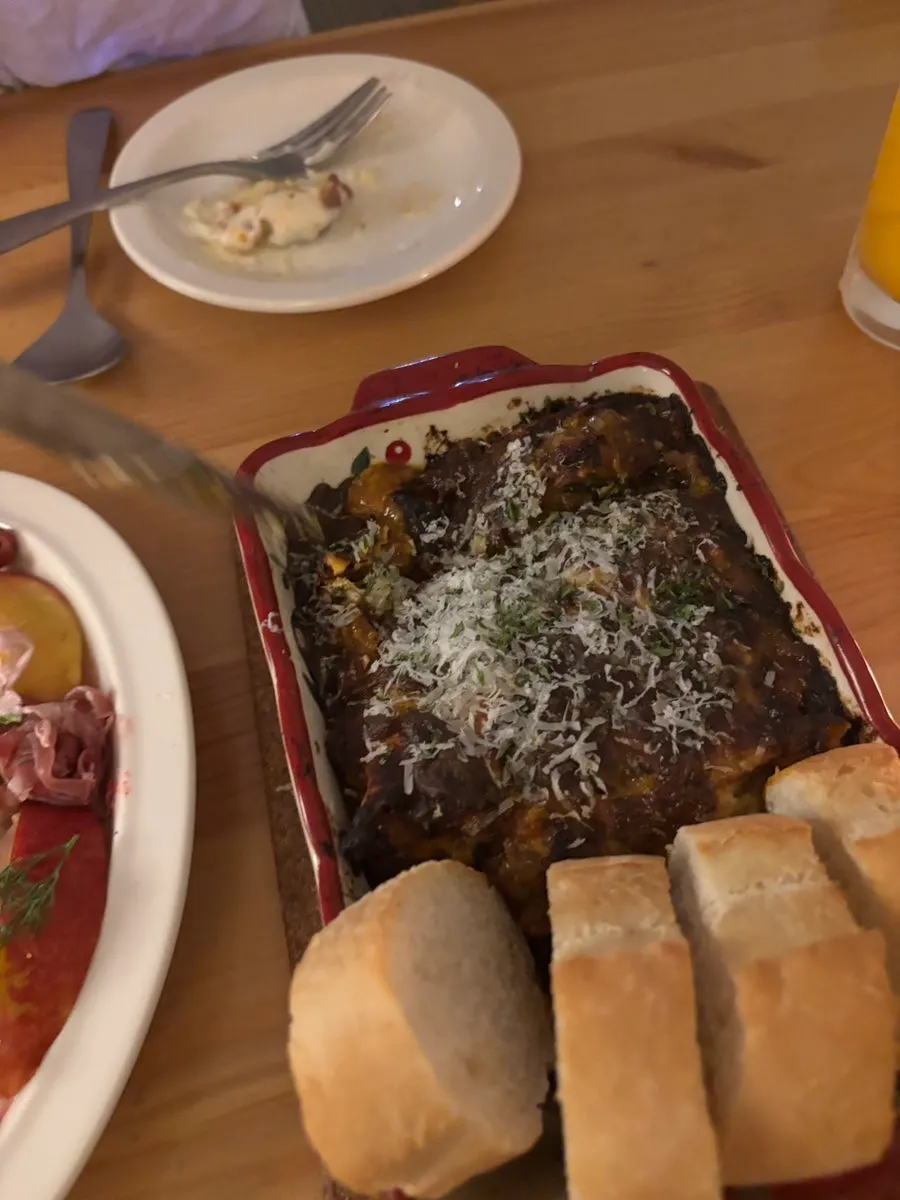 Four pieces of baguette served alongside the lasagna