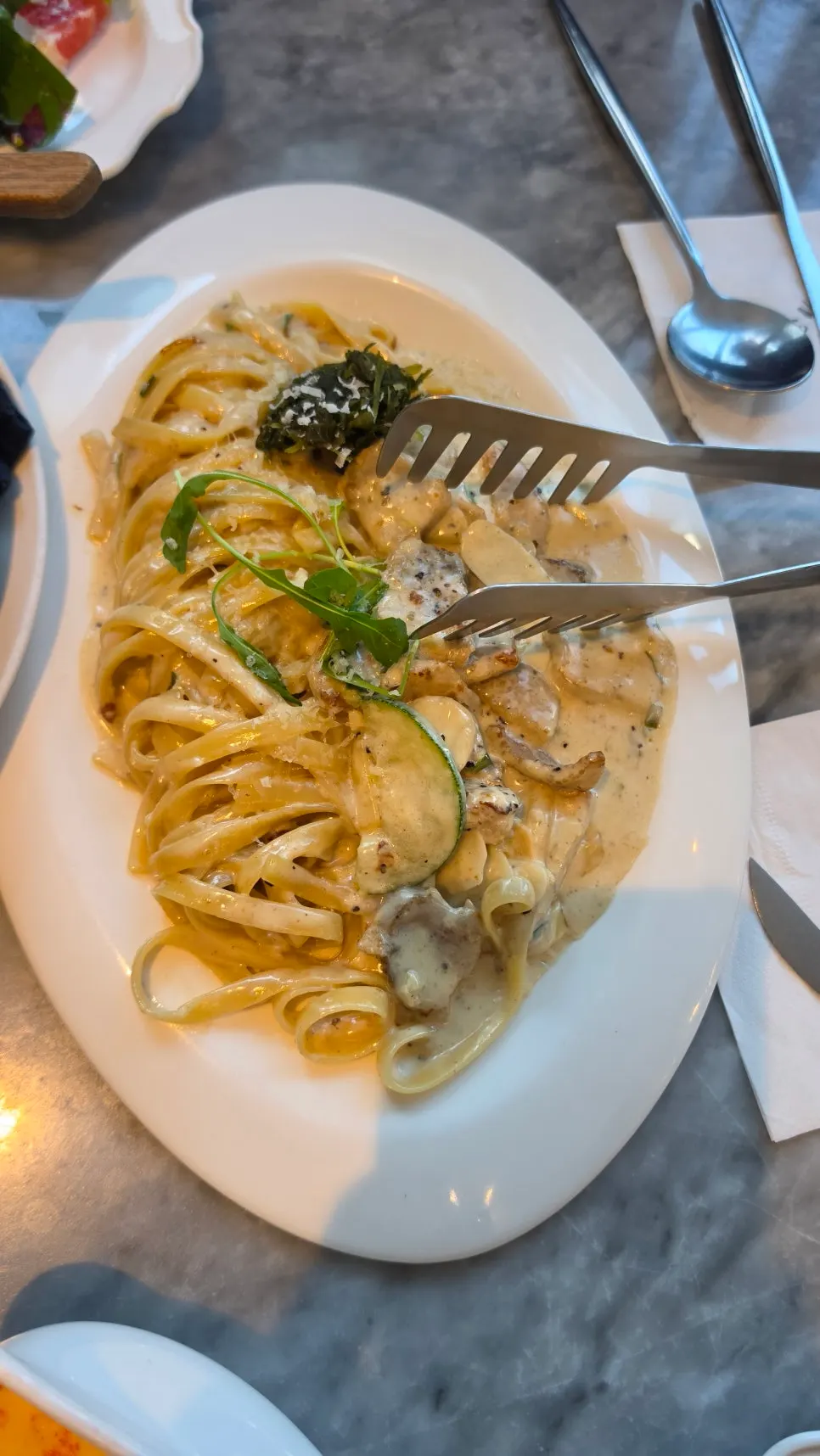 Cream pasta topped with grilled pork jowl