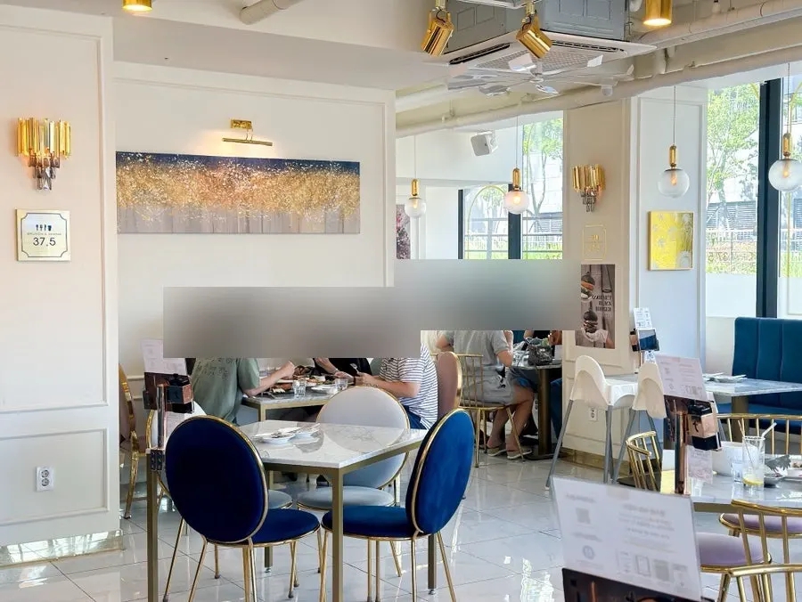 Restaurant interior with white walls and gold frames