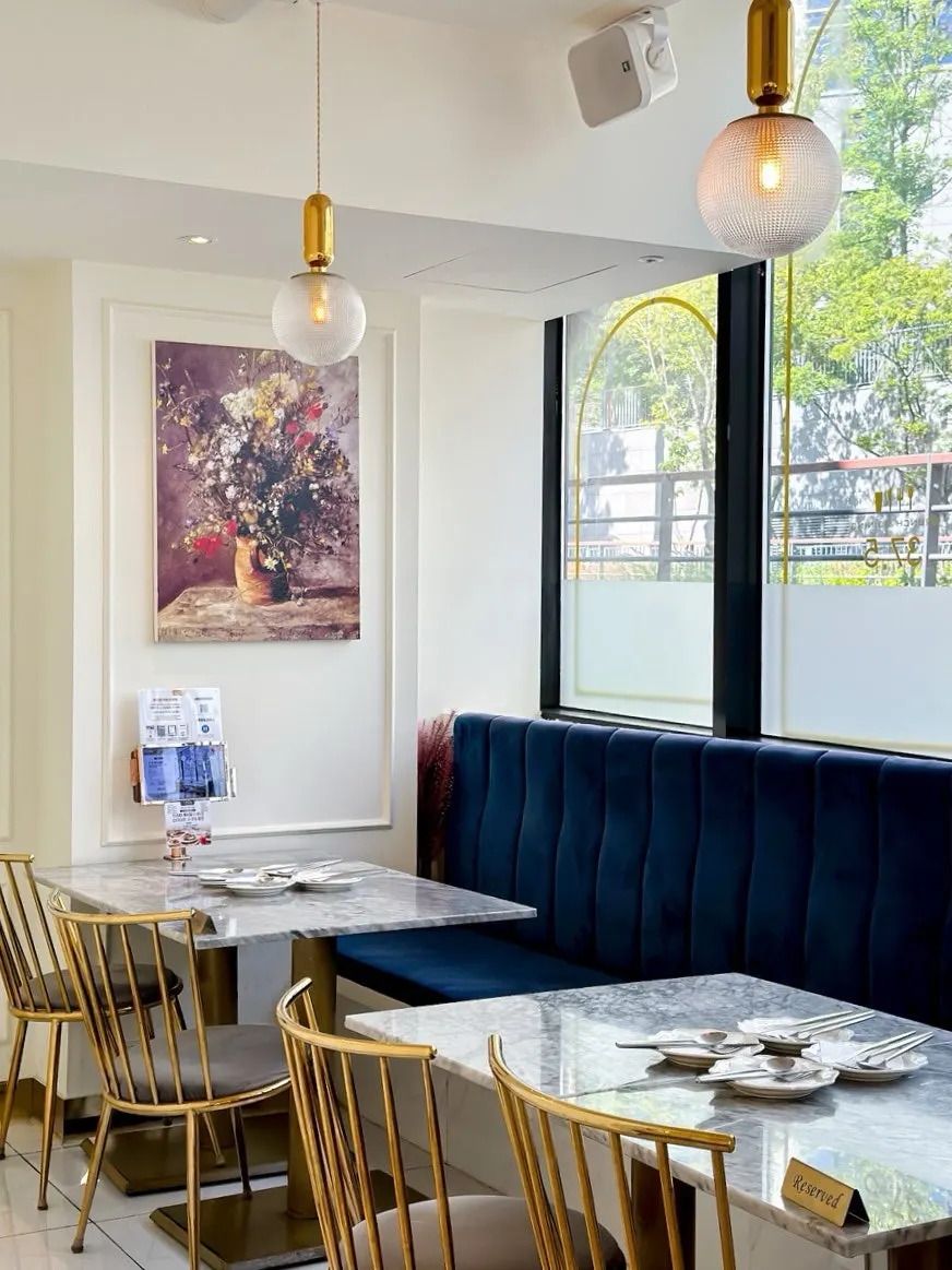 Window seating with arched floor-to-ceiling windows and marble tables