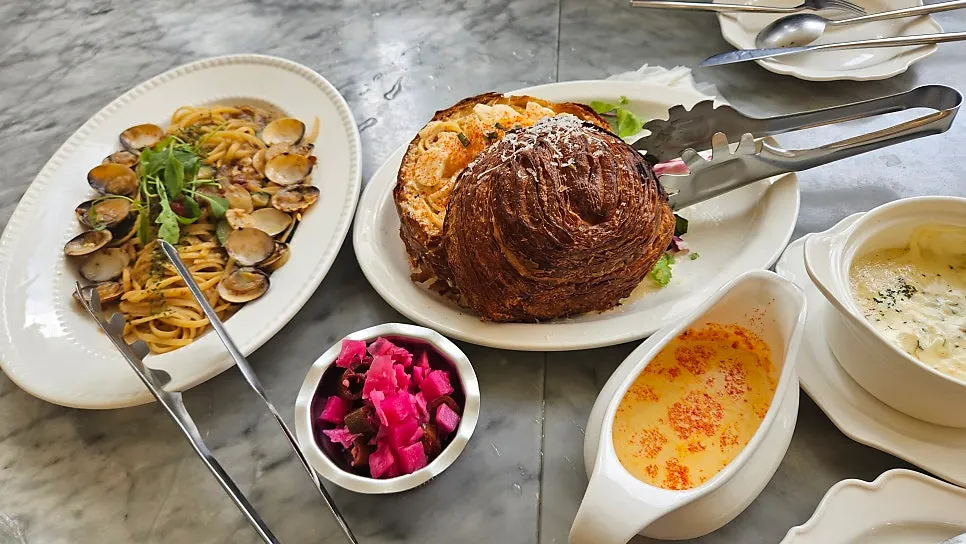 Table set with brunch, pasta, and soup