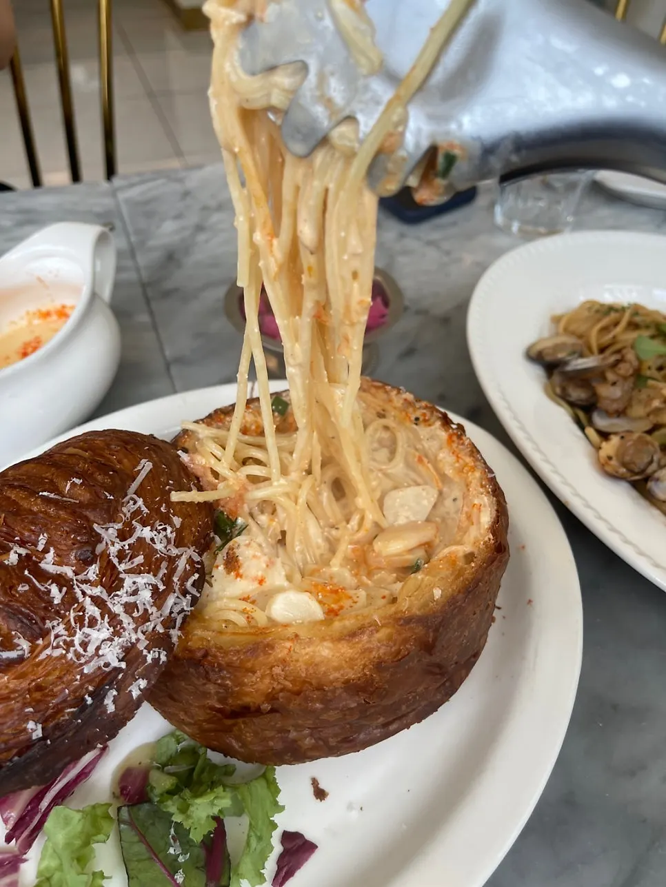 Pasta lifted from inside the bread