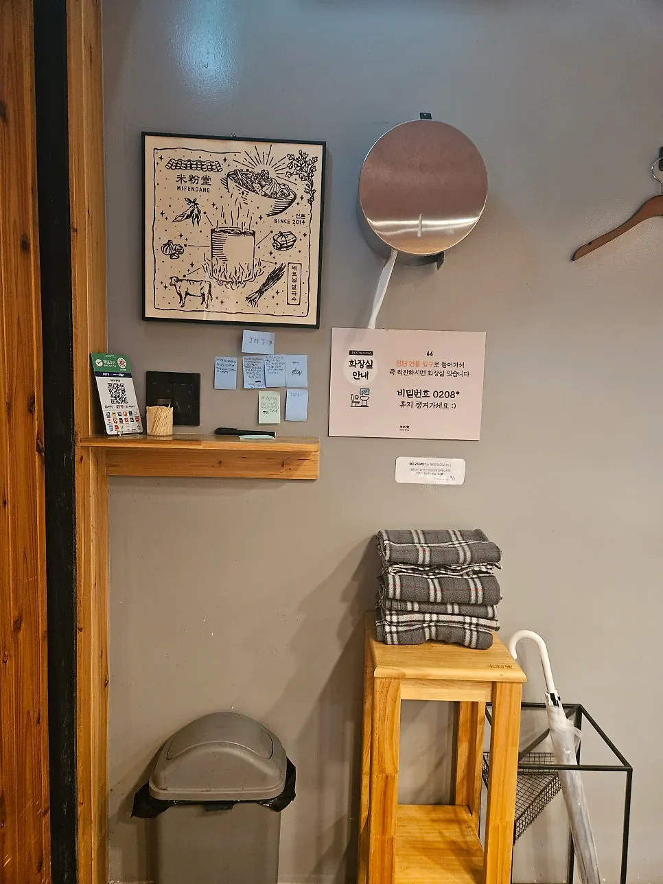 Coat hooks behind the seats and the wall of the restaurant