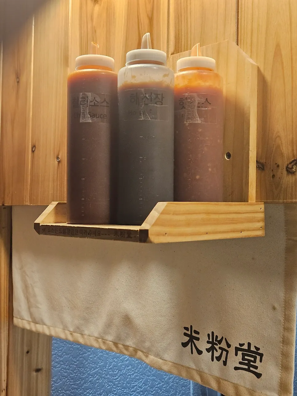 Hoisin, chili, and hot sauce on the shelf