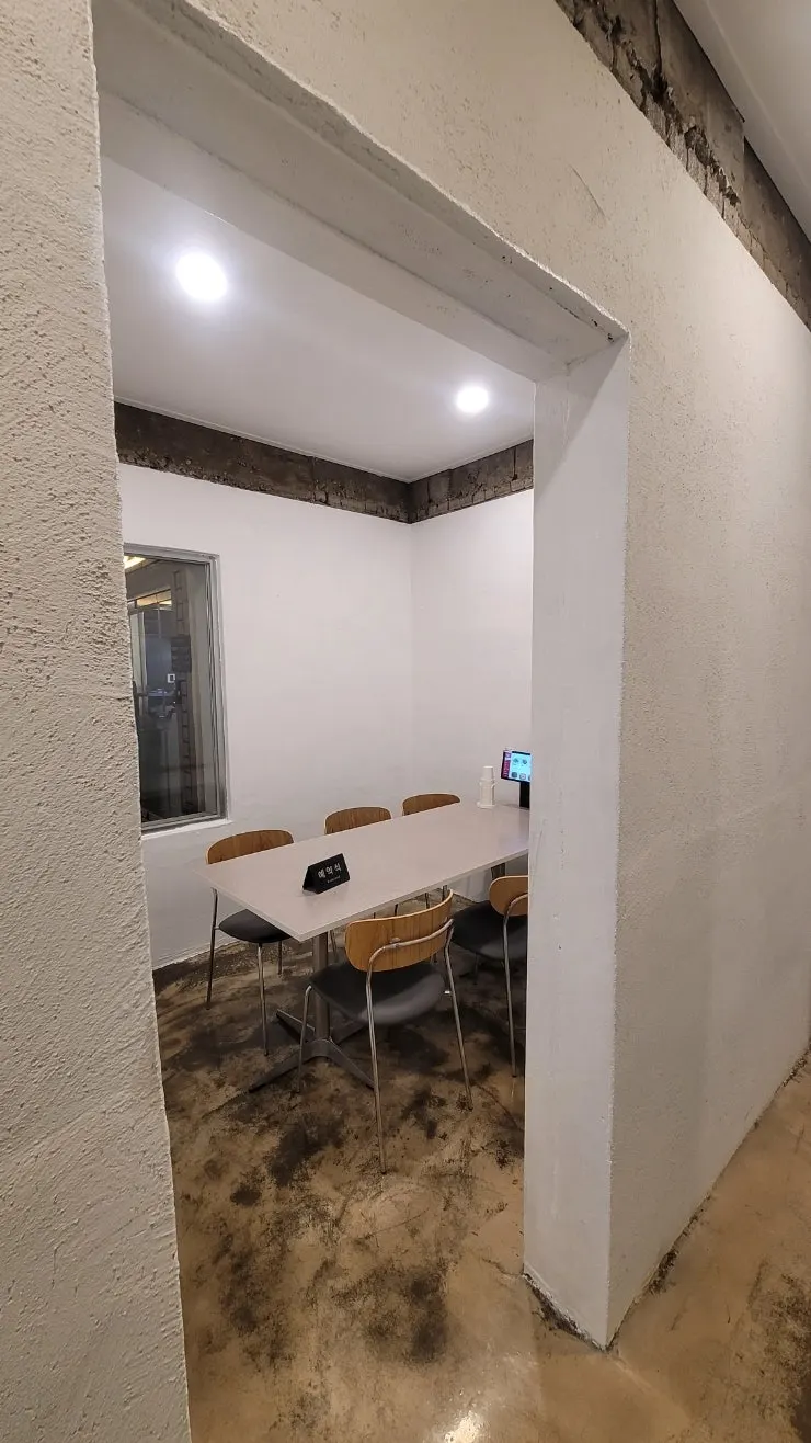 Midam Kitchen interior mixing exposed concrete and white tones