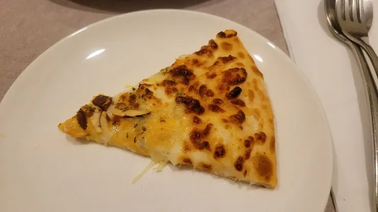 Whole quattro cheese pizza with melted cheese
