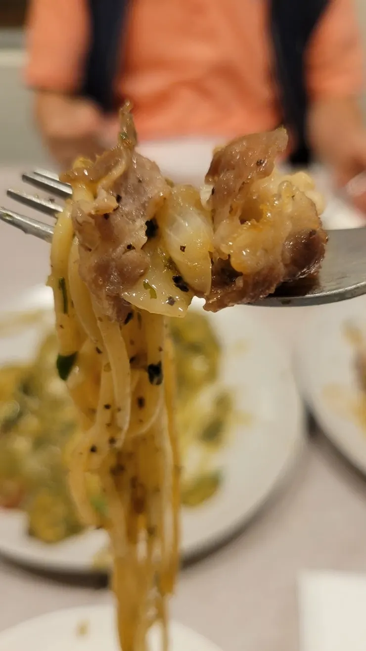 Pizza and pasta served out onto plates