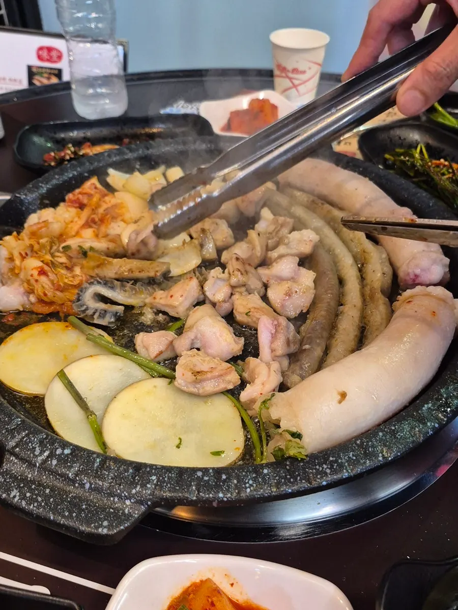 Side dishes set out in front of the grill