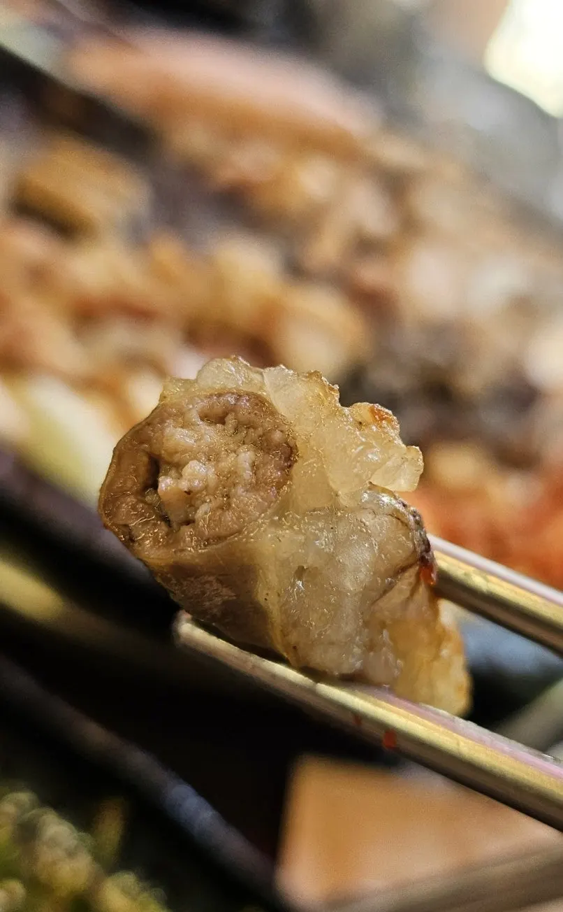 Close-up of makchang grilling on the plate