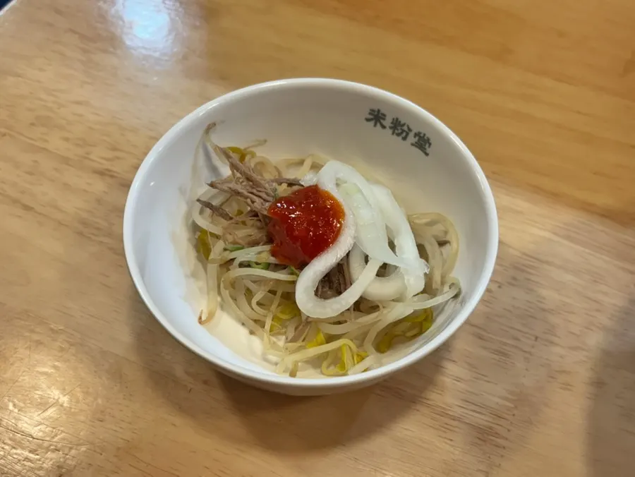 Pho mixed with hoisin sauce and hot sauce
