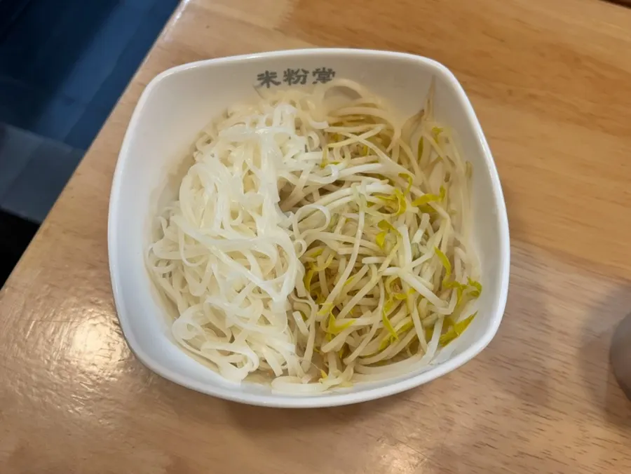 A large plate of refilled noodles and bean sprouts