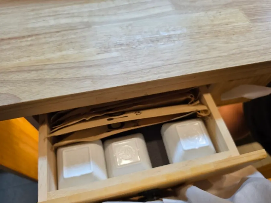 Small sauce dishes inside the front drawer