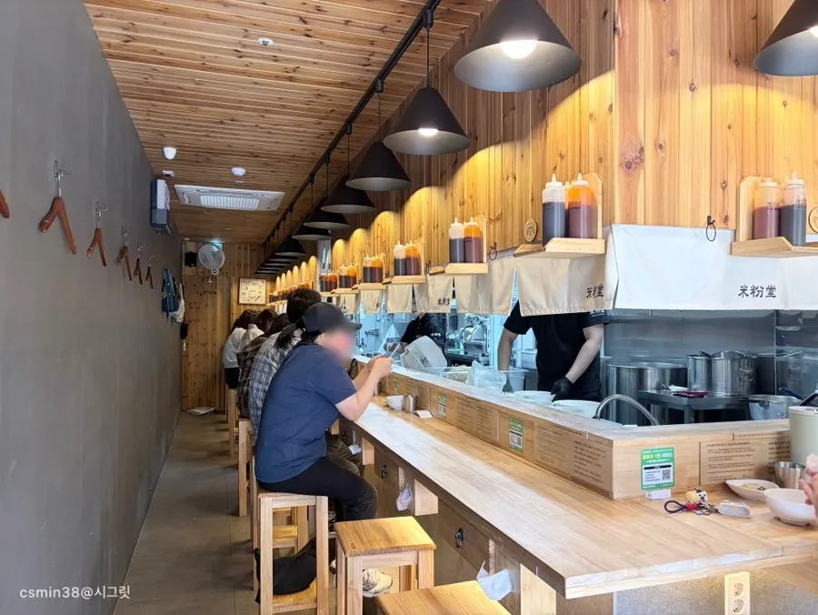 Long wooden bar table running along the wall