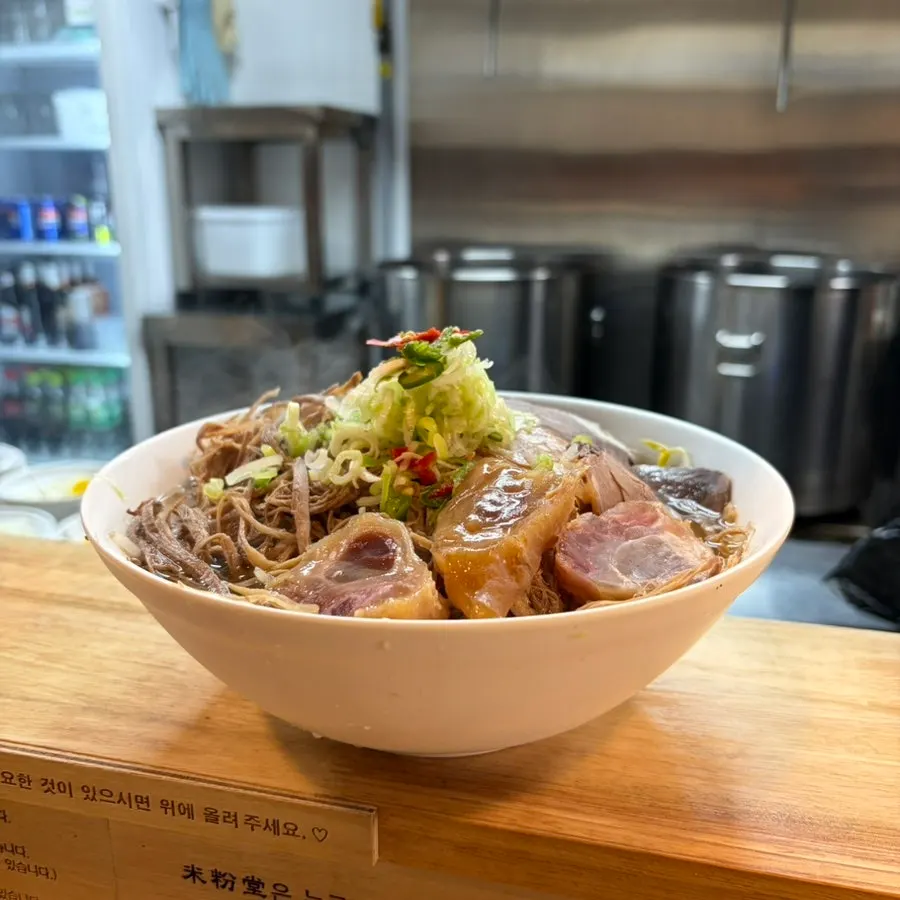 A bowl of beef brisket-tendon pho covered in meat