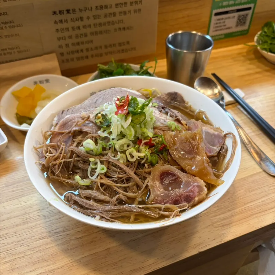 Close-up of the broth and meat in beef brisket-tendon pho