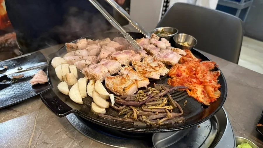 Staff grilling the meat as part of the tableside grilling service