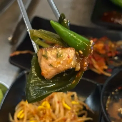 A piece of meat placed on wrap vegetables