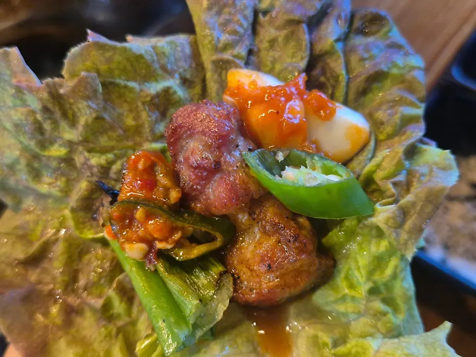 A table set with meat and lettuce wraps