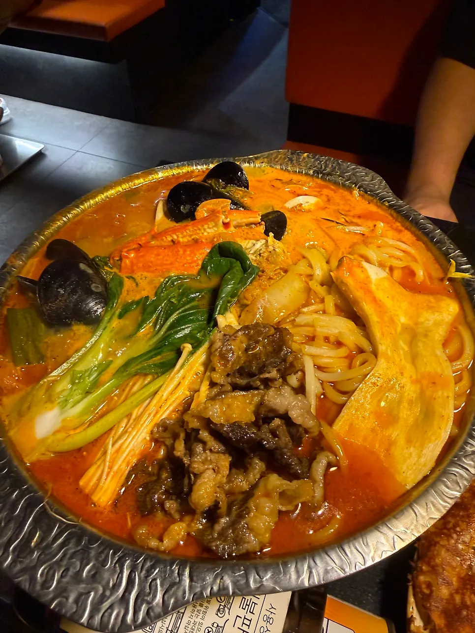 Ingredients for brisket jjamppong hot pot on a burner