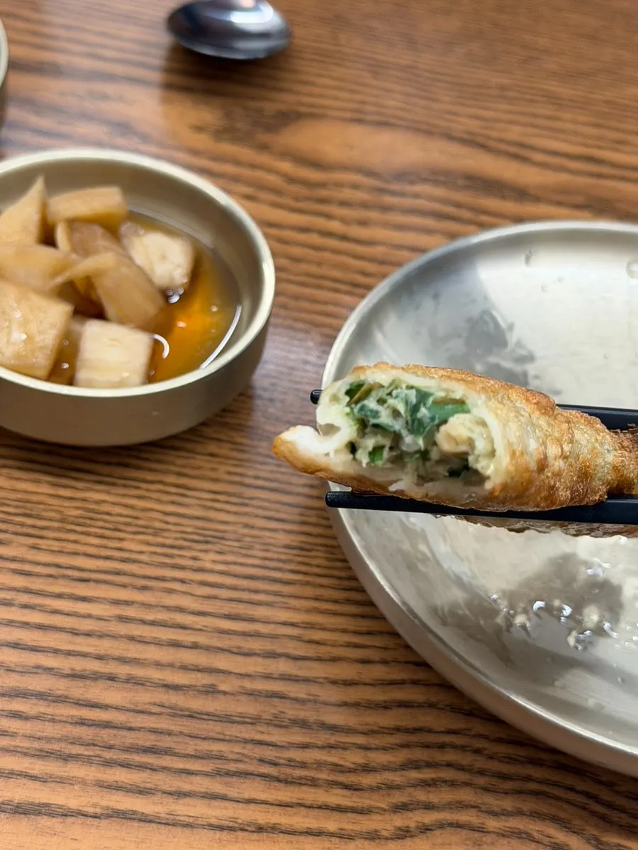 Cross-section of a fried dumpling dipped in soy sauce