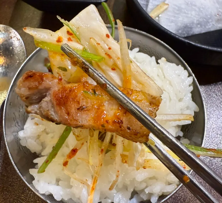 A piece of pork belly placed on radish pickle