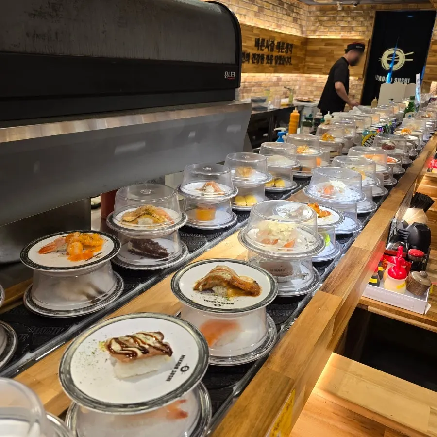 Sushi plates circling on the conveyor rail