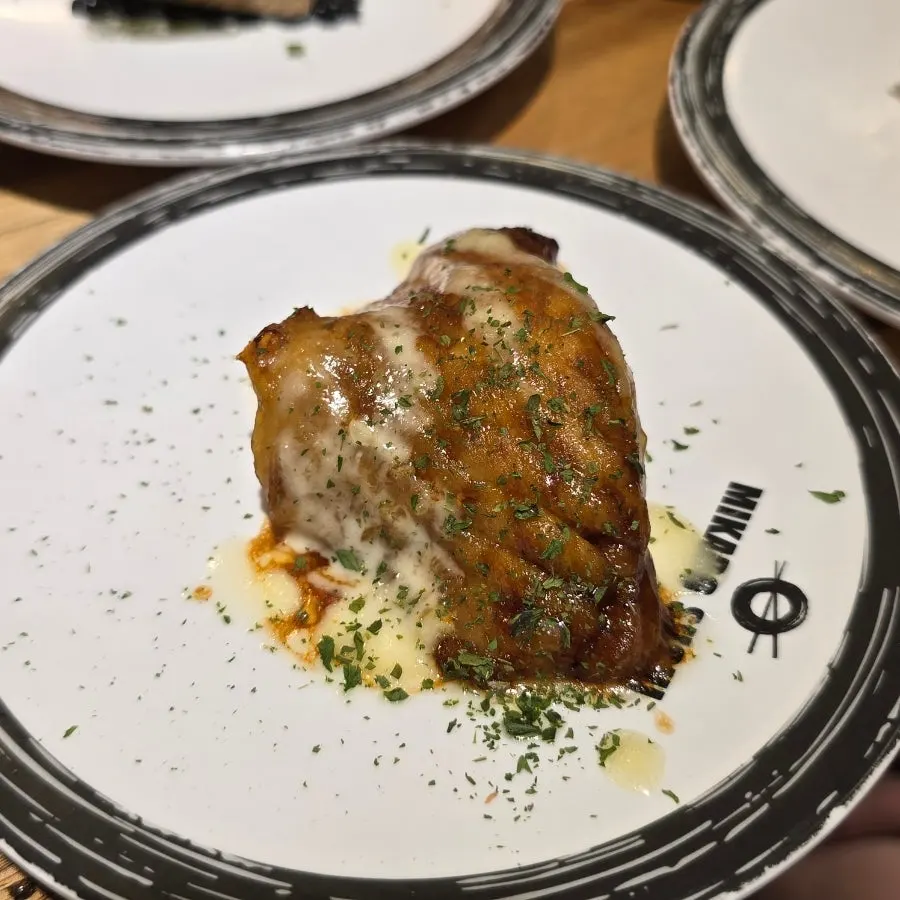 Plate of sauce-topped sushi
