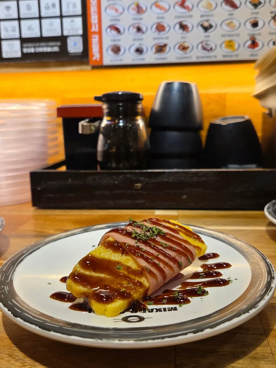 Close-up of sushi topped with garnish