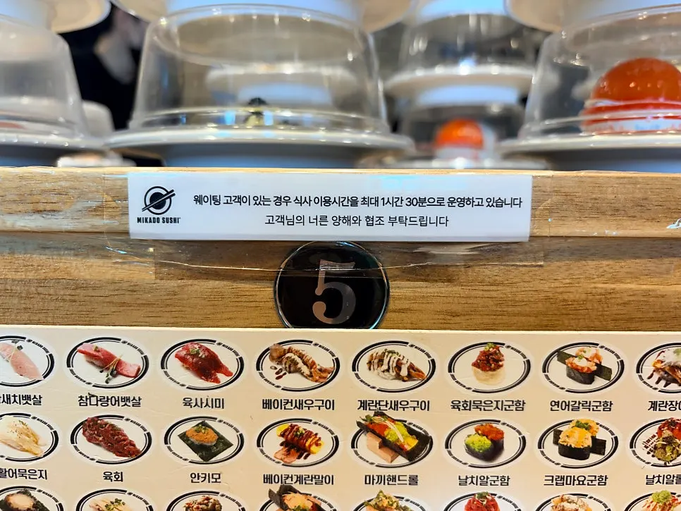 Interior seating along the conveyor rail at Mikado Sushi