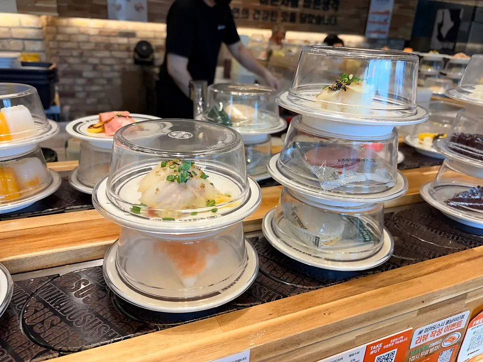Various sushi plates rotating on the conveyor rail